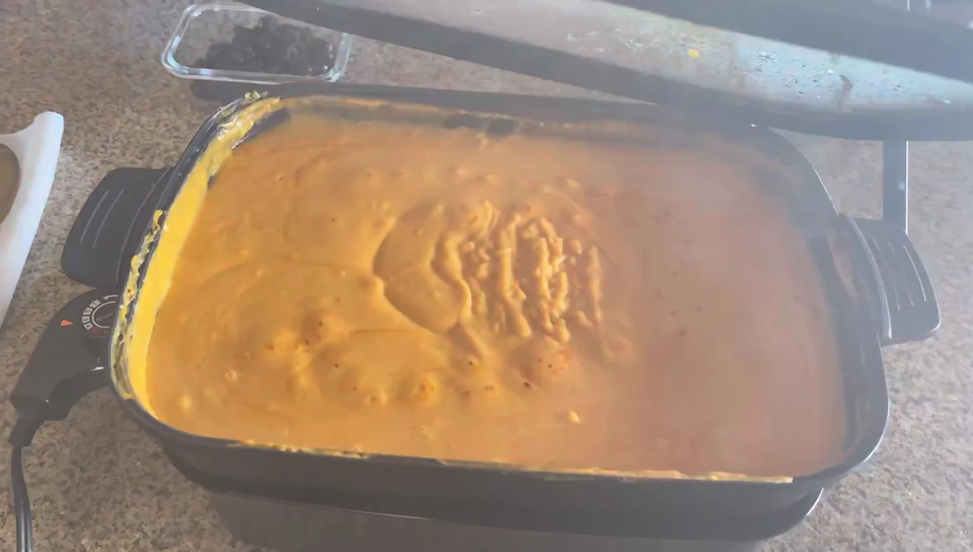 Nacho cheese being melted on the griddle.