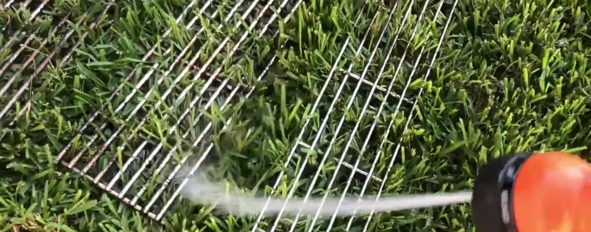 Cleaning dirty grill grates with water.