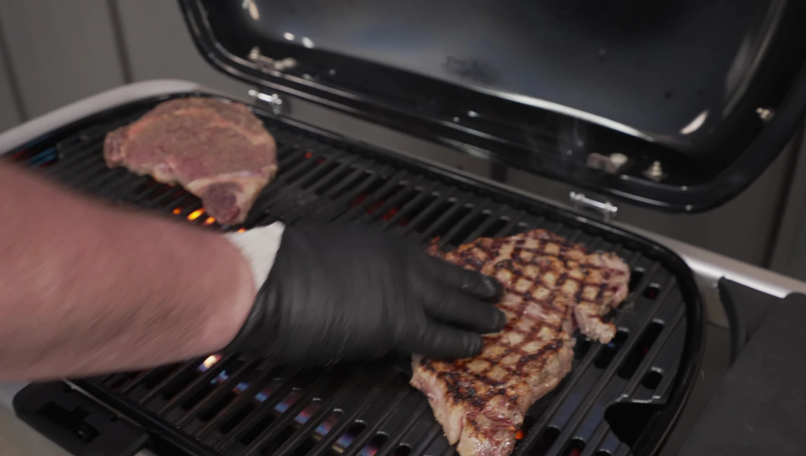 Steaks cooking on the grill, showcasing the even cooking and sear marks.