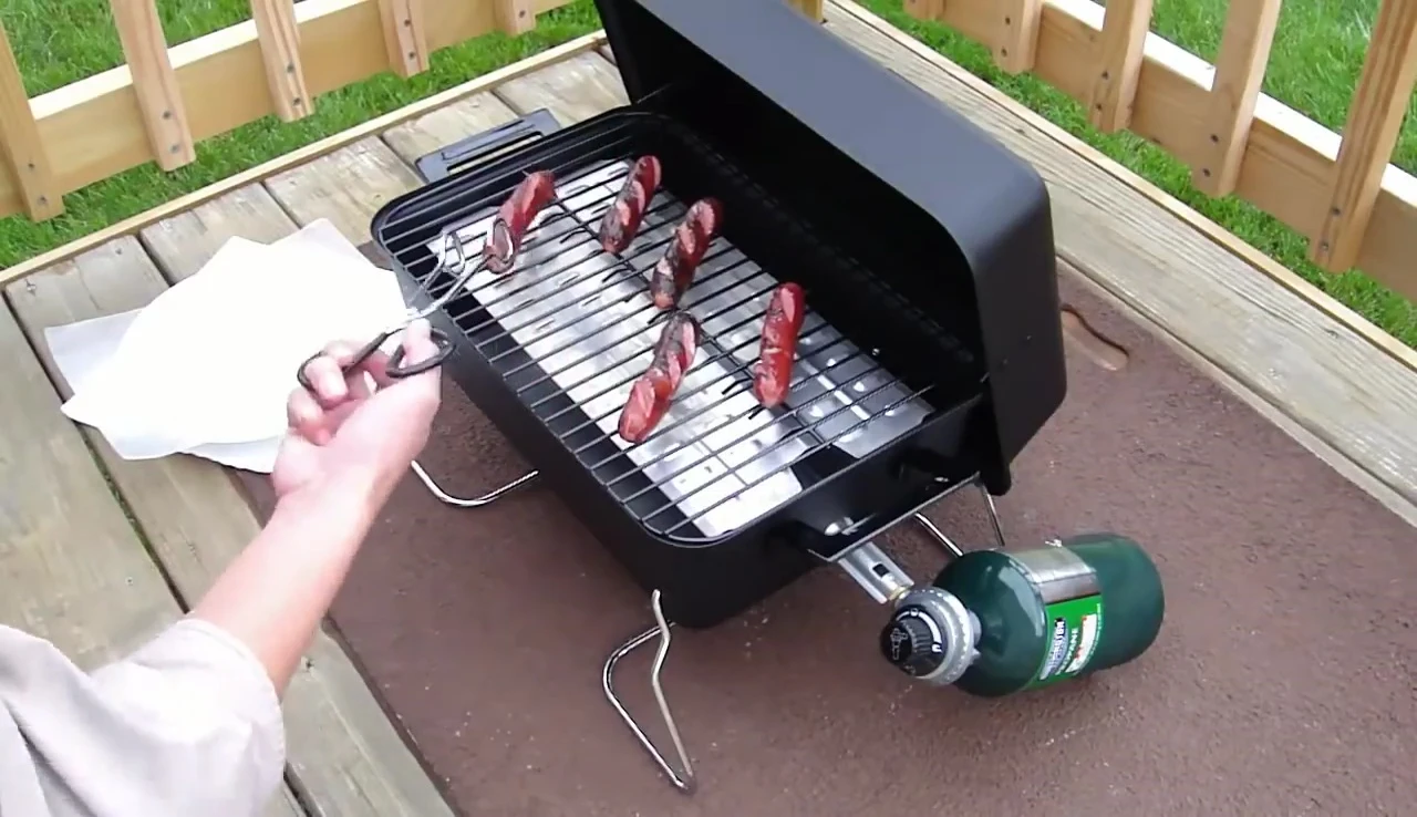 Grill lid open showing the burner noise.