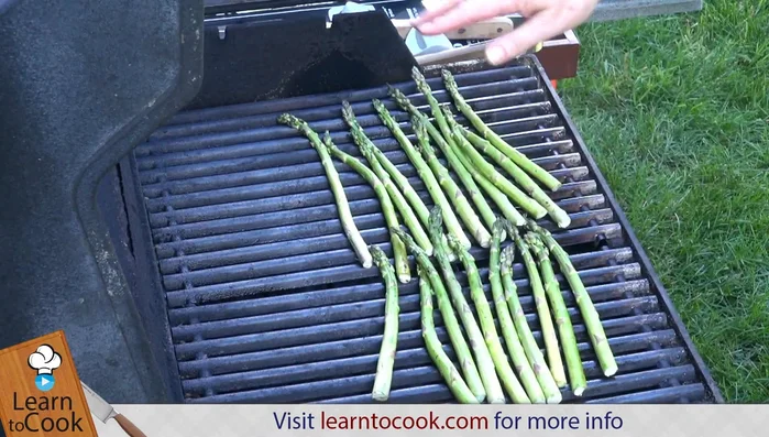 Grill asparagus until browned on one side.