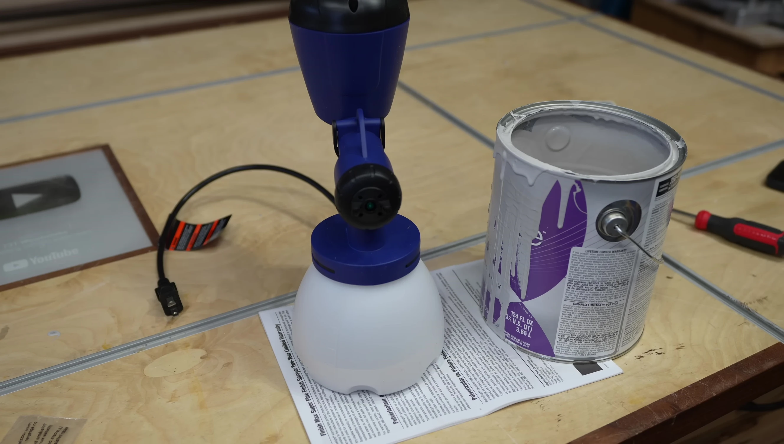 The sprayer in action, painting a surface.