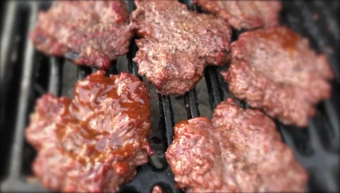 Flip burgers to the hot side for a few seconds to sear. Then flip again to cook the other side quickly.