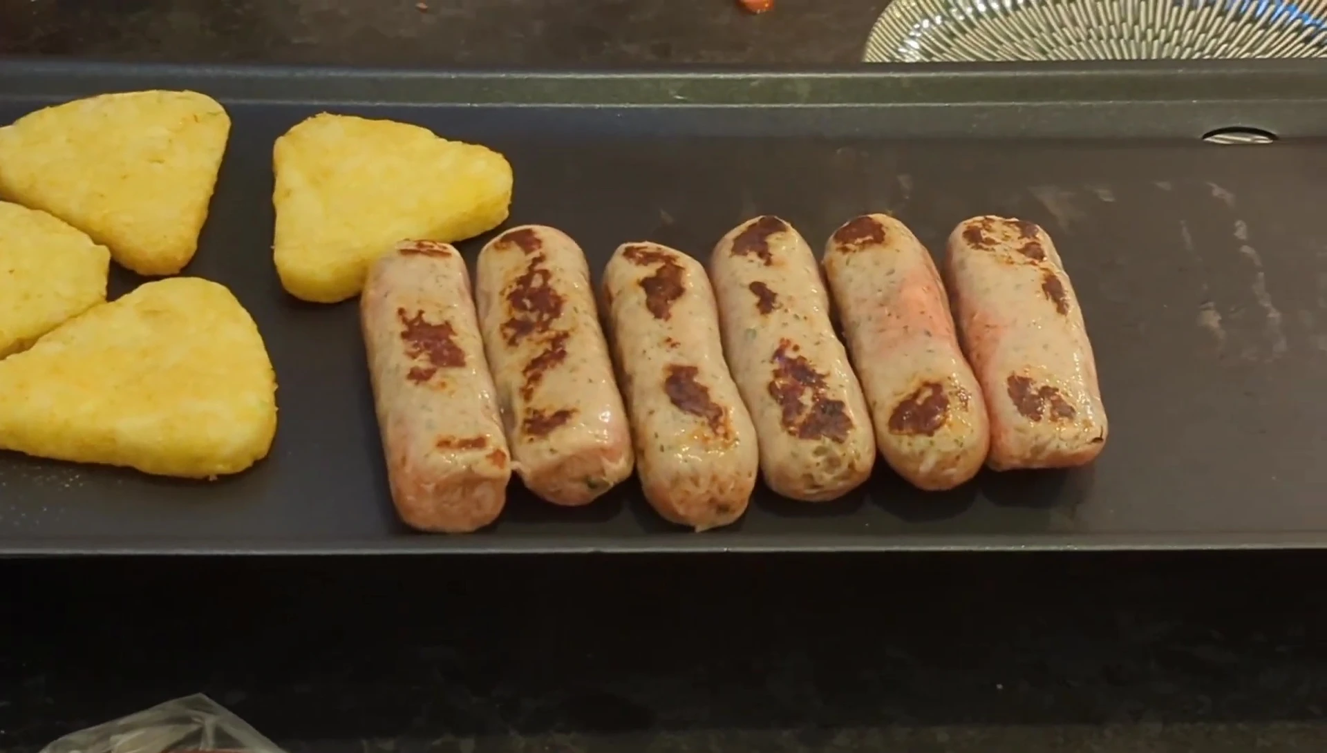 Sausages and black pudding cooking