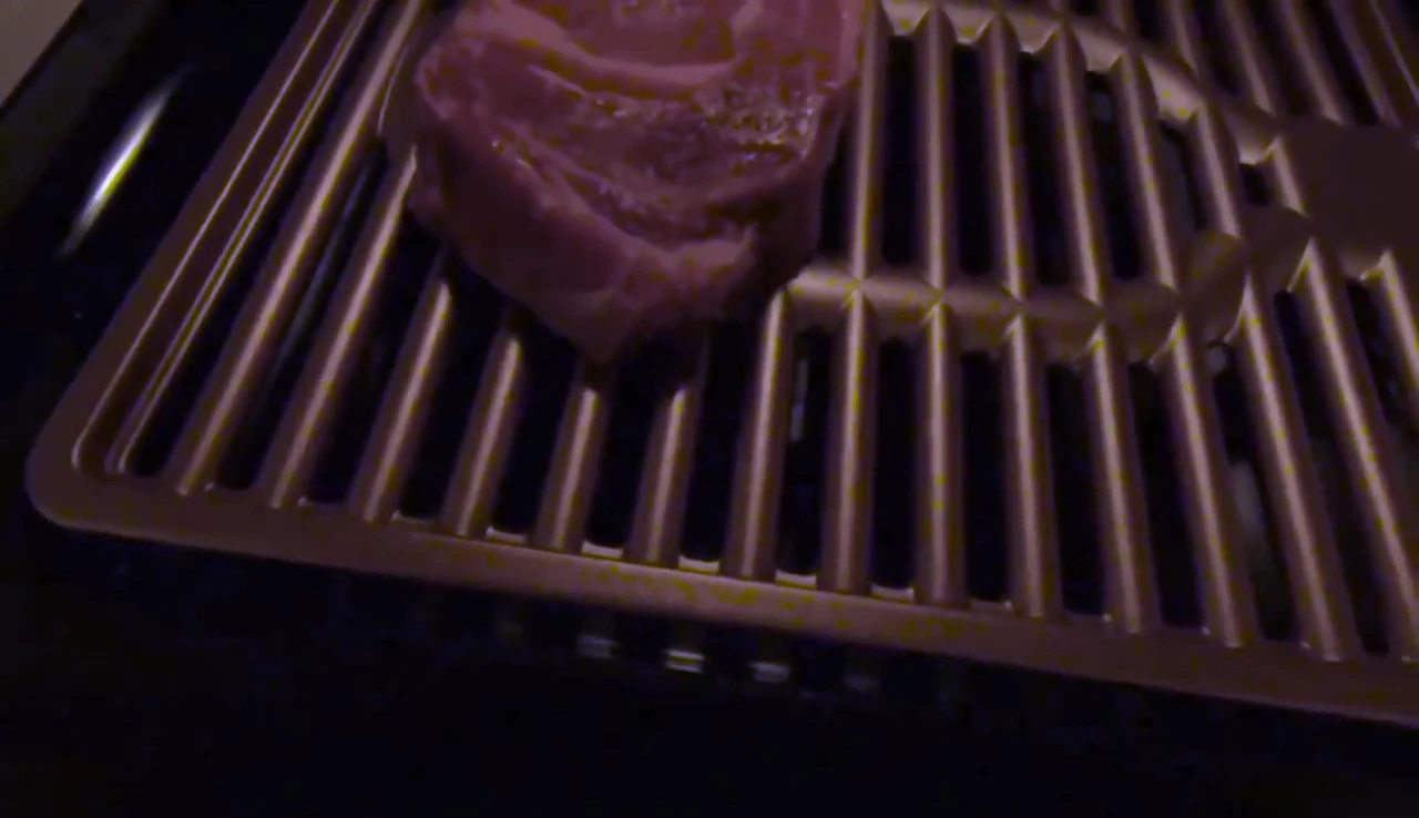 Steaks cooking on the grill with minimal smoke.