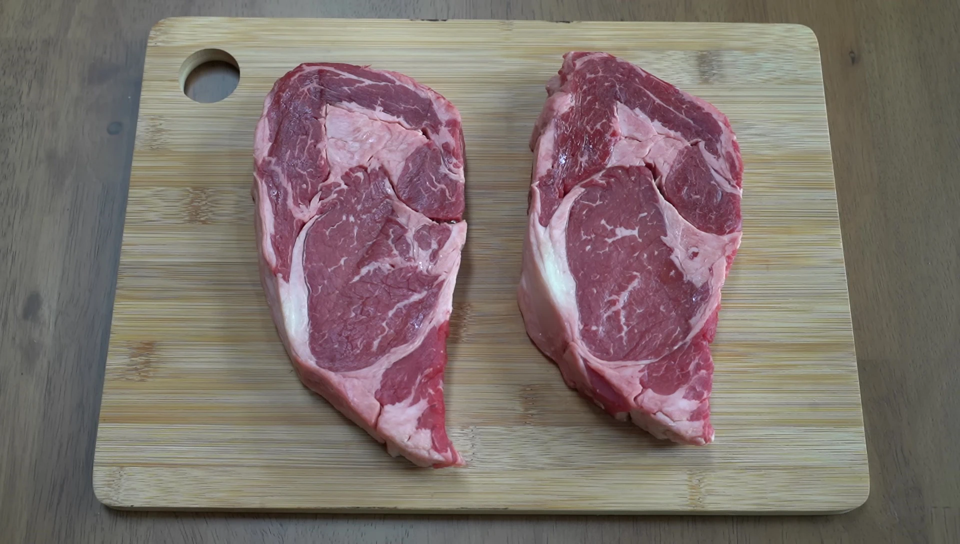 Close-up of the two ribeye steaks being prepared