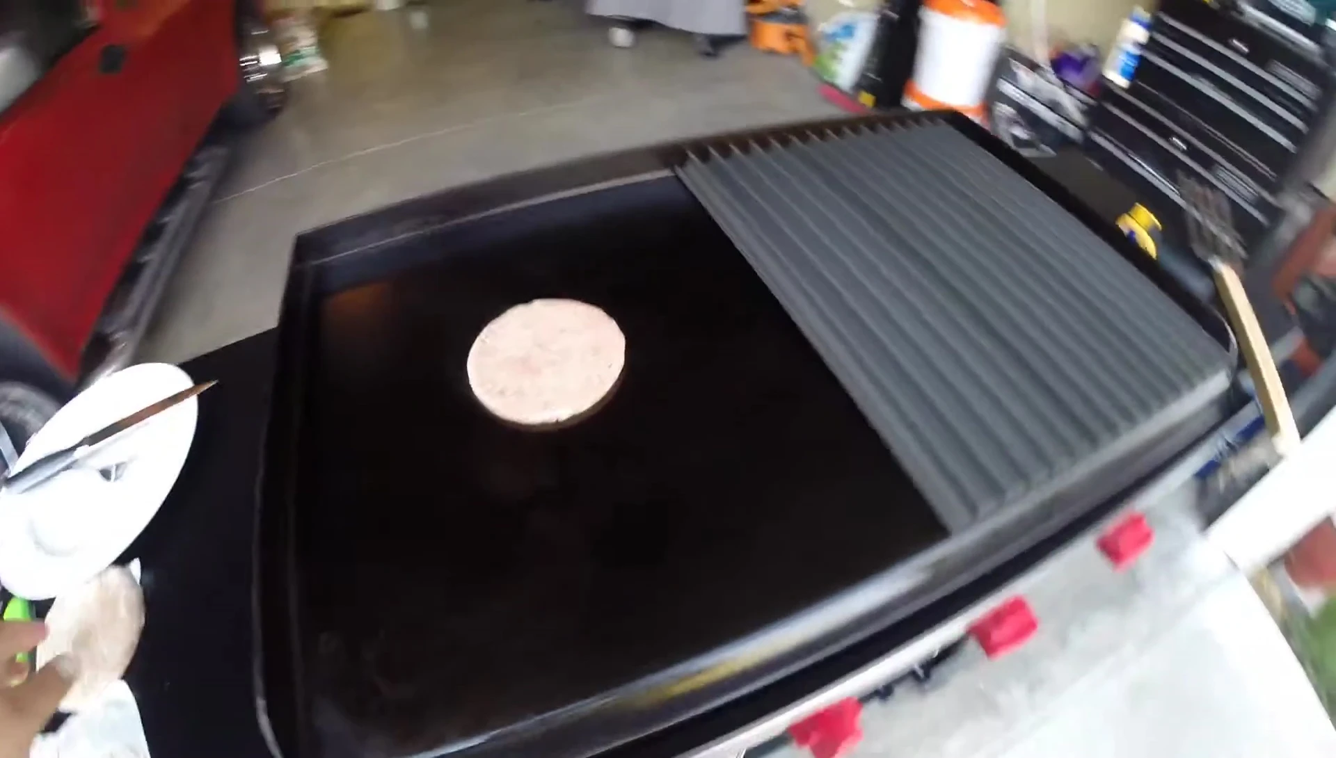 Burgers cooking; one directly on the griddle, one on the Grill Grates.