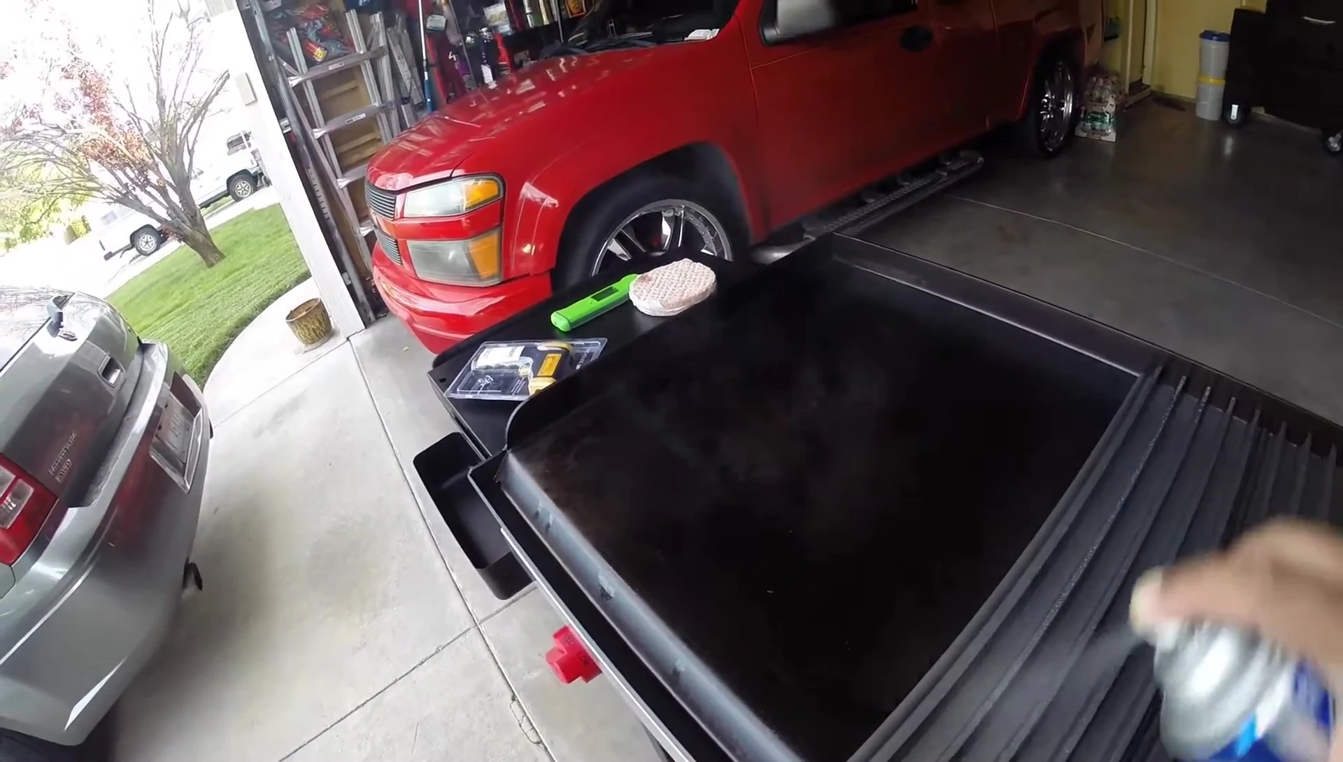 Applying cooking spray to the preheated Grill Grates