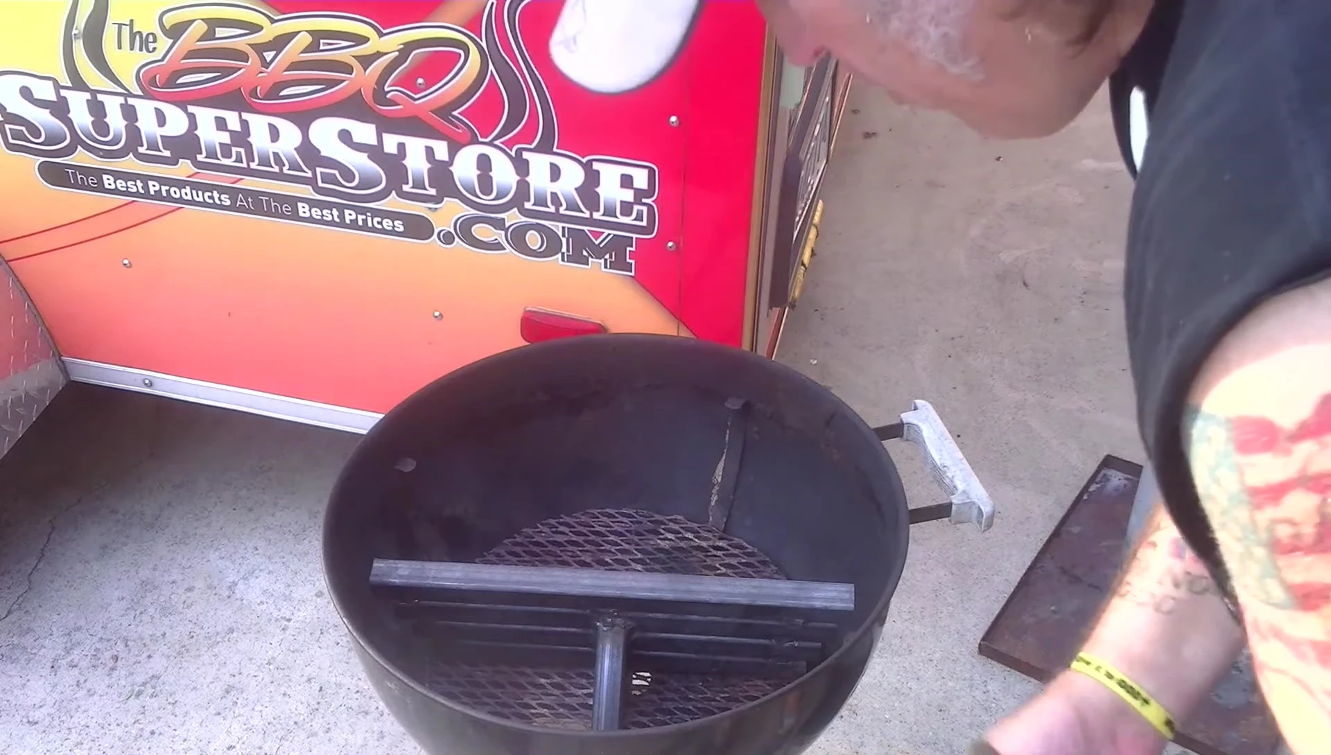 Close-up of the XXL Champion Charcoal Basket Separator Bar, highlighting its sturdy construction.