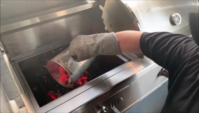 Dump the coals into your grill using heat-resistant gloves.