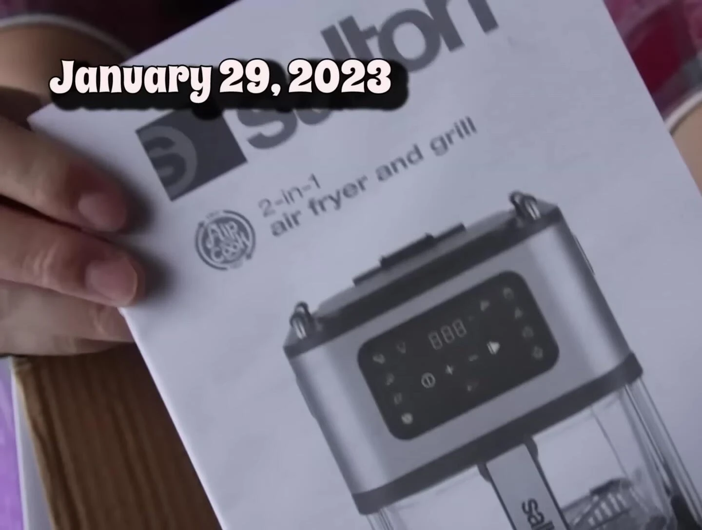 Close-up of the Salton air fryer box being opened.