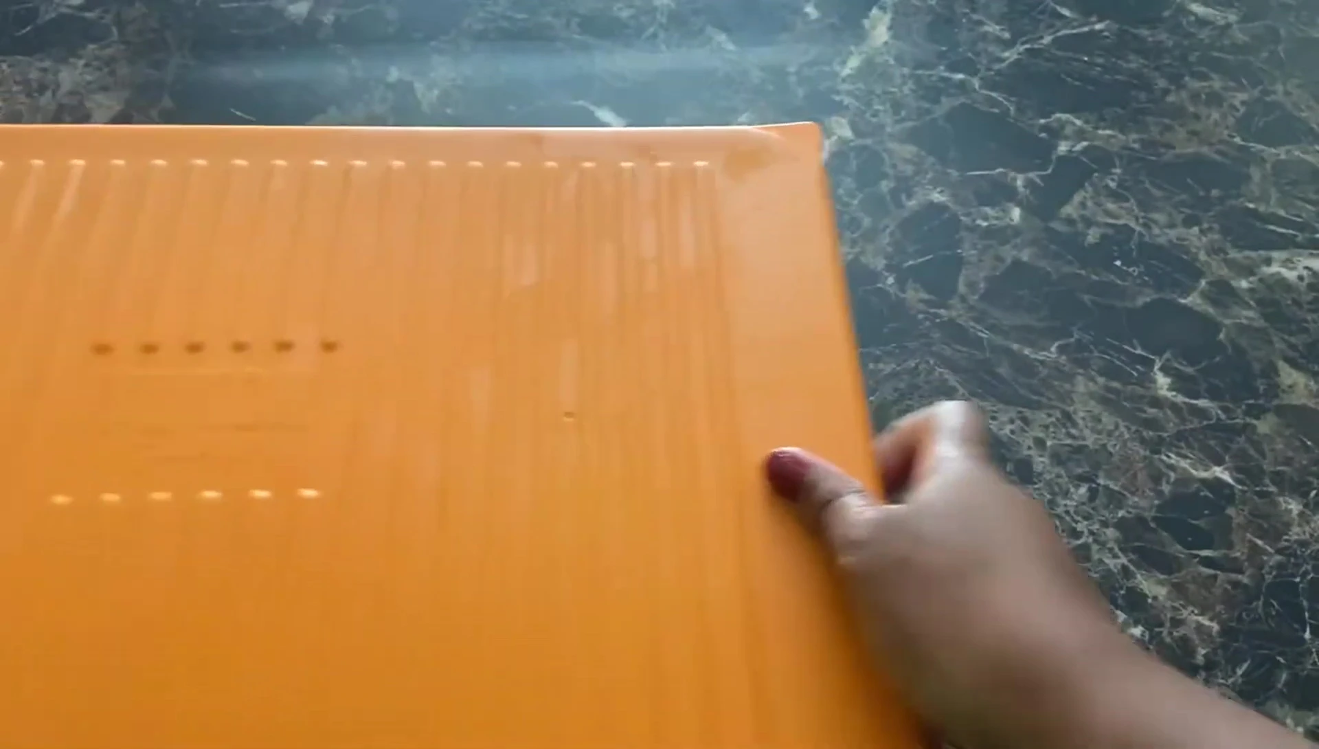 The reviewer displaying the trays nested together for storage.