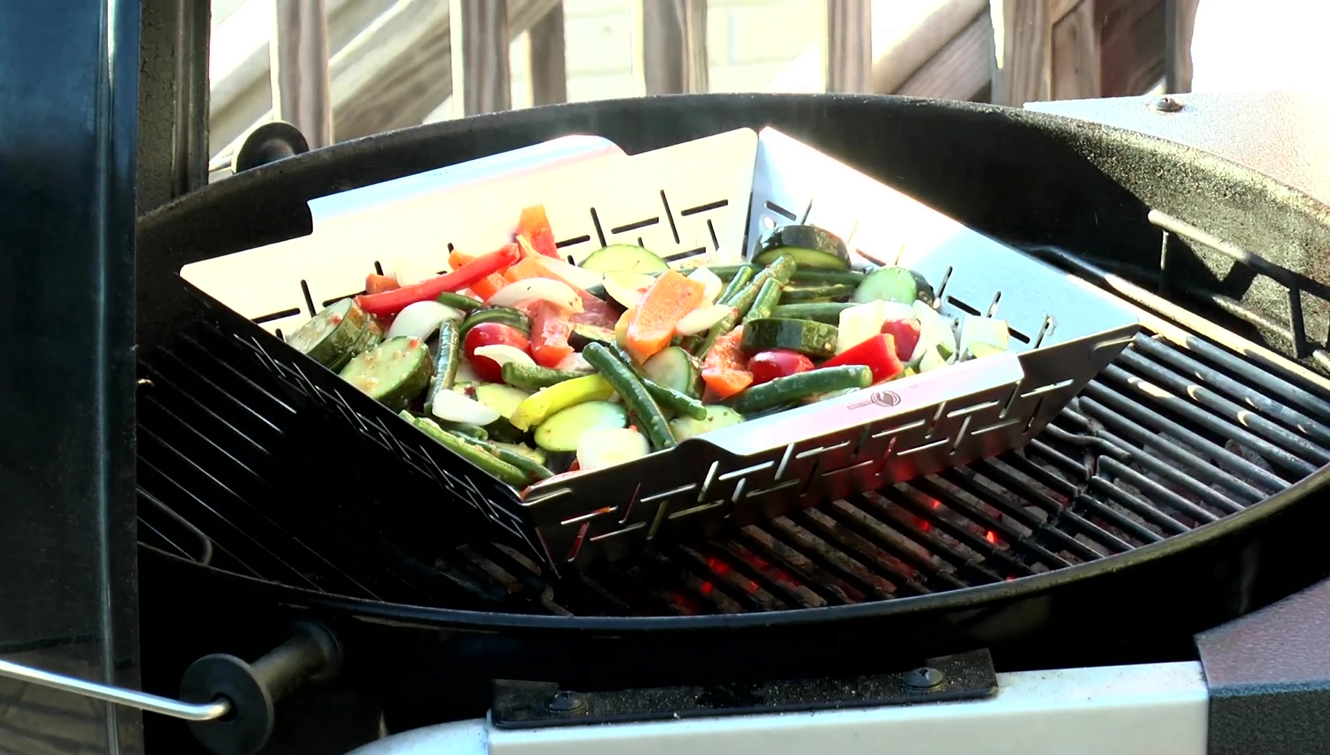 The grill basket on the grill, showcasing the even cooking.
