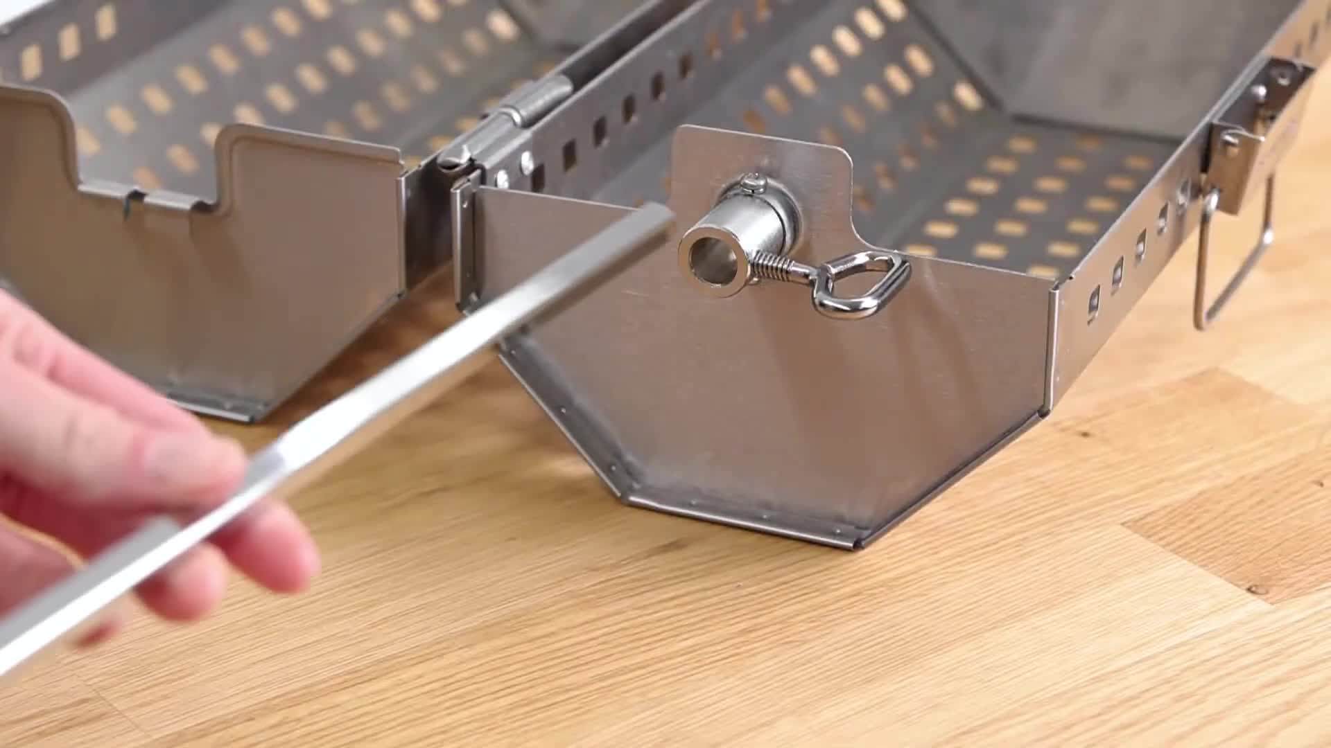 Detailed view of the basket attaching to the rotisserie rod.