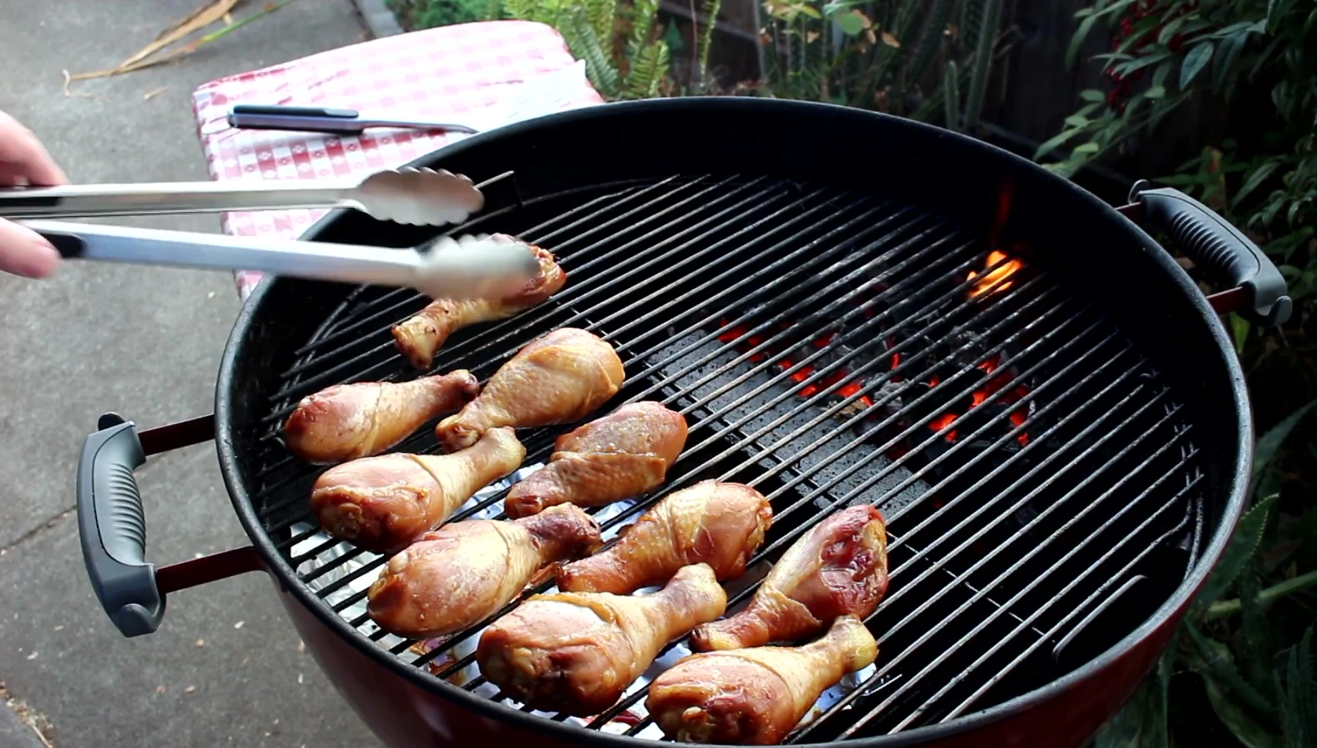 Using the OXO tongs to flip the chicken