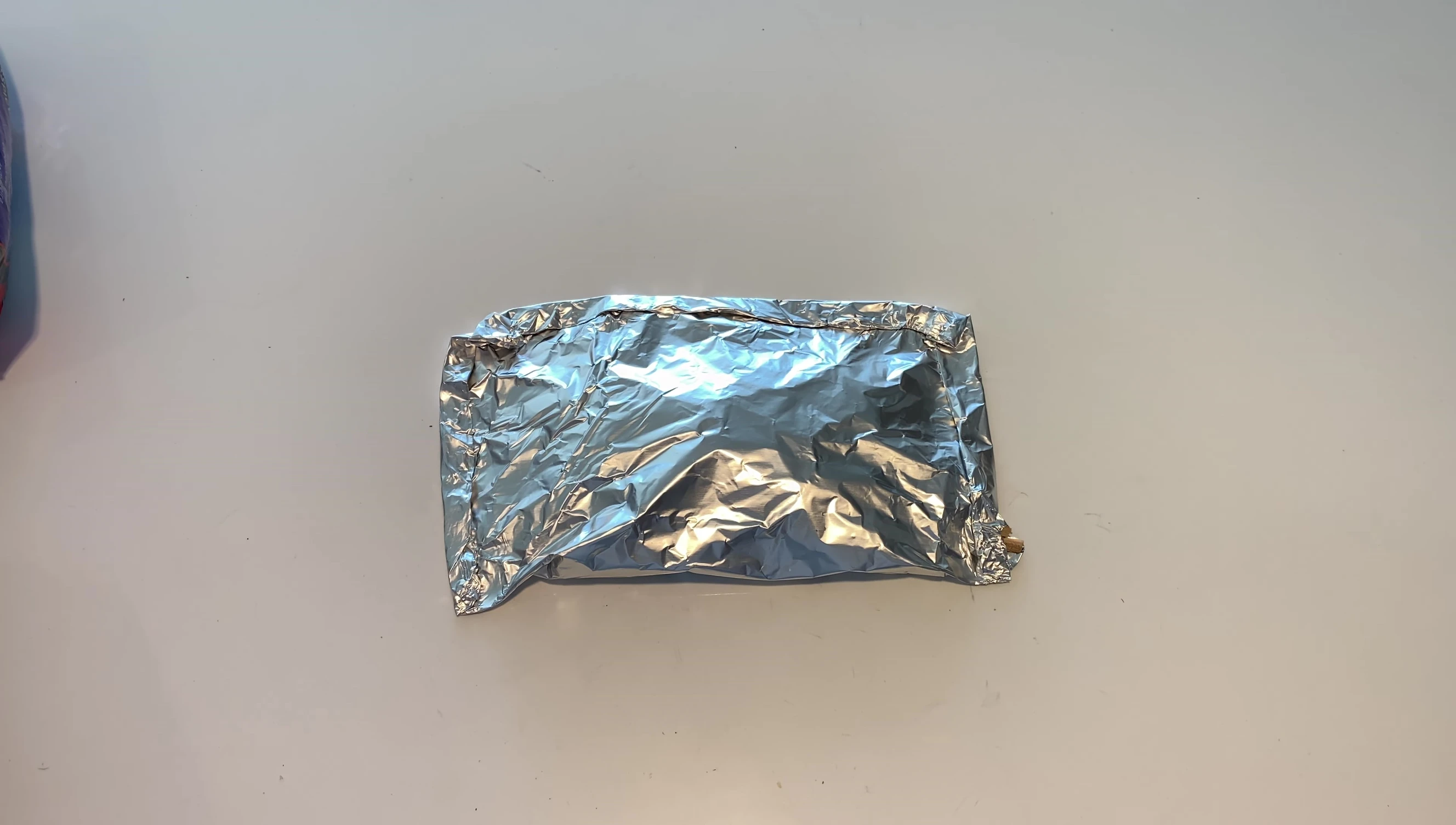Poking a hole in the top of the foil packet.