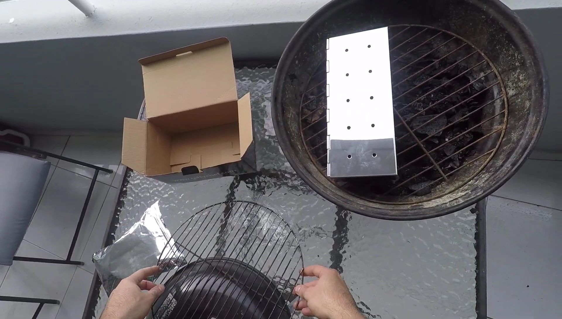 Placing the smoker box on a small portable grill.