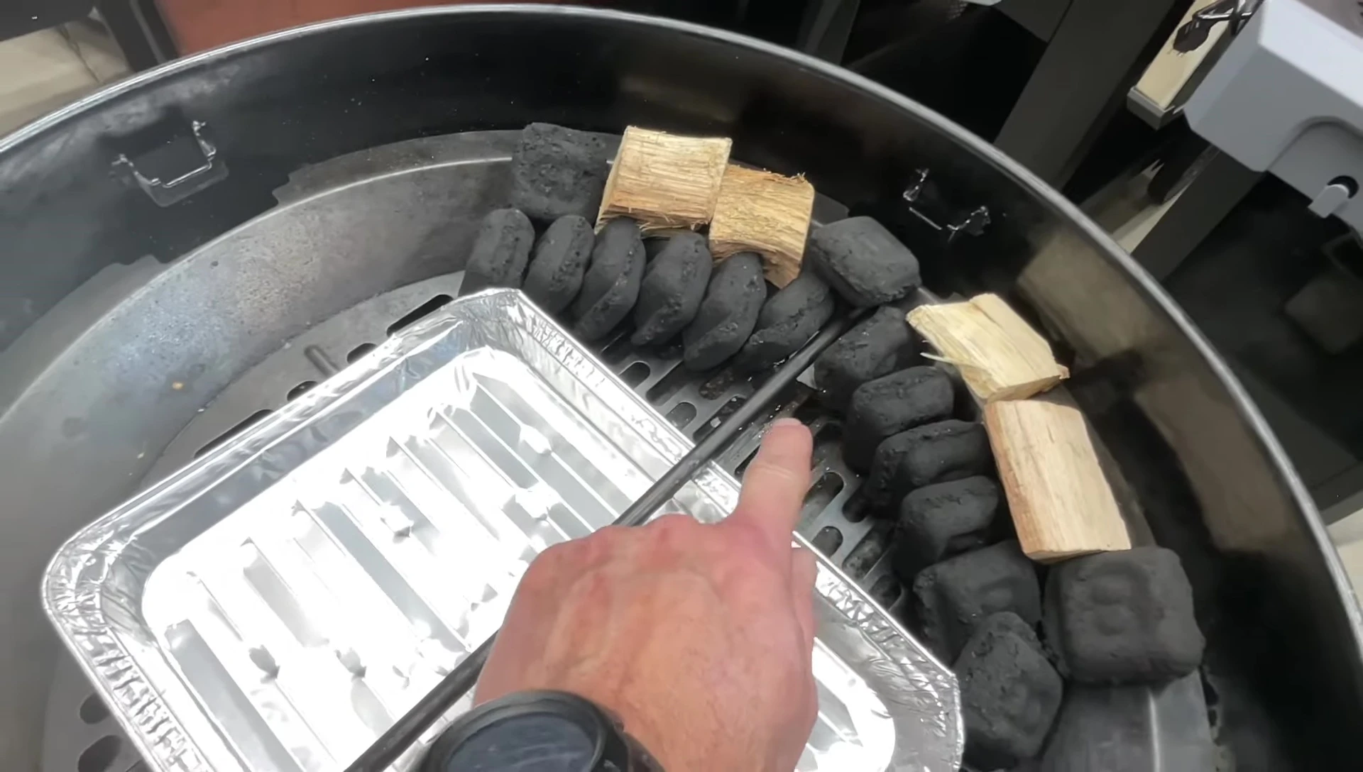 Charcoal and wood chunks arranged in the grill
