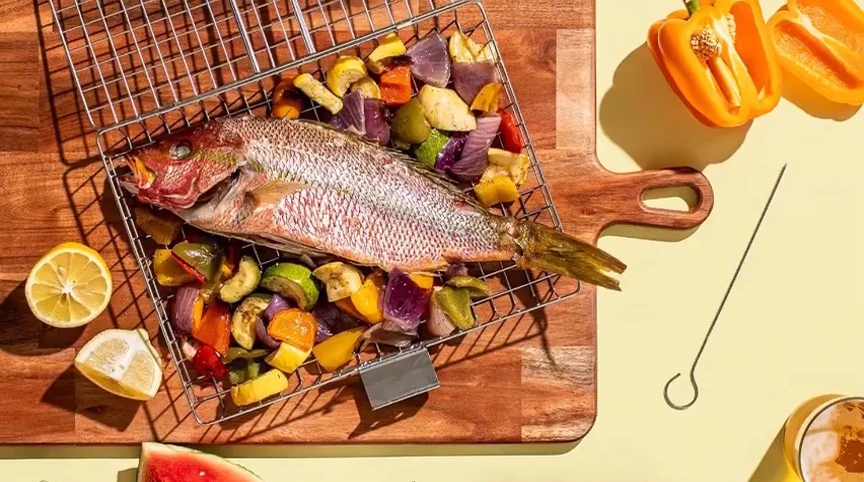 Basket being used to grill various foods.