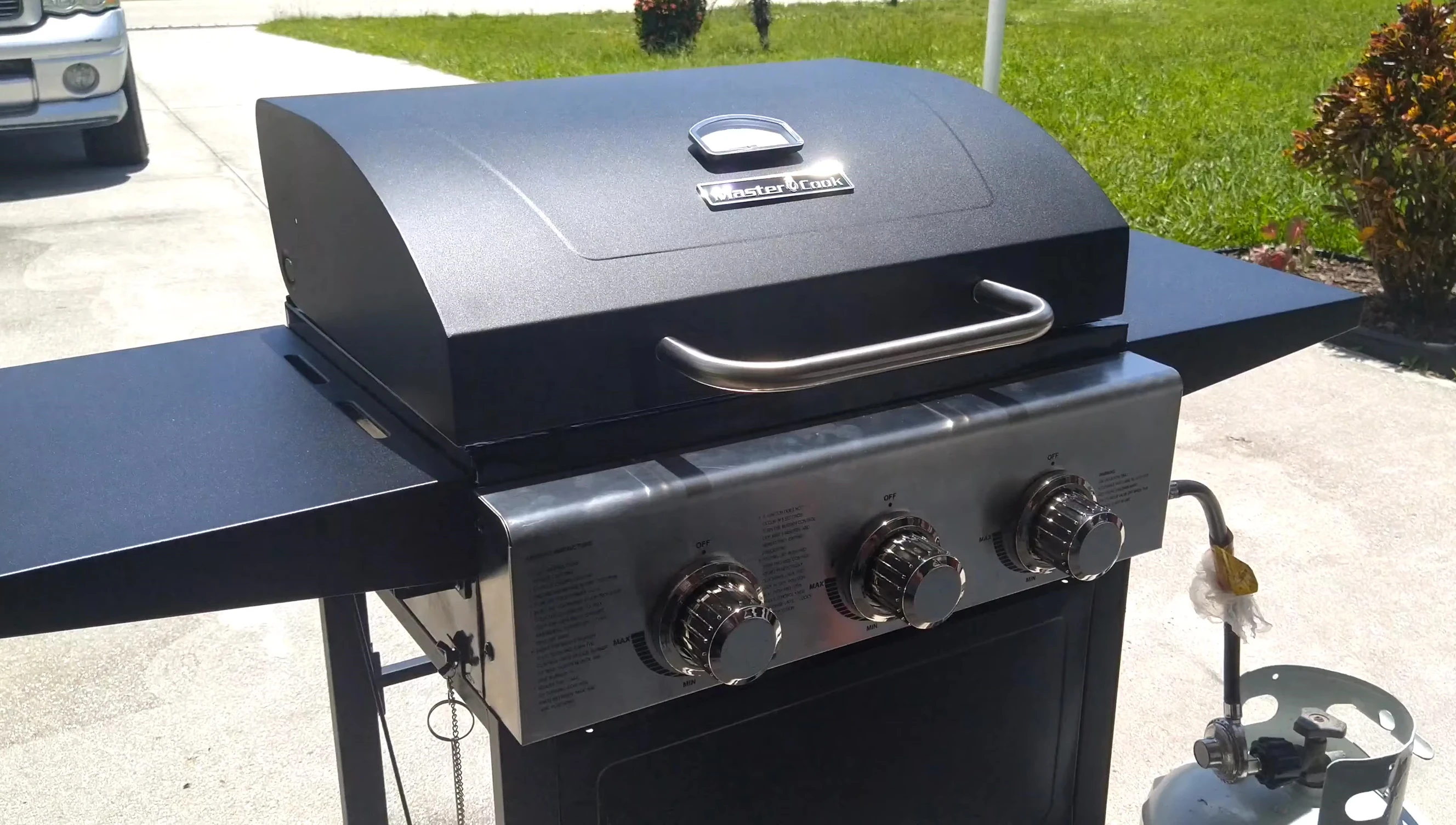 Lifting the grill hood before lighting