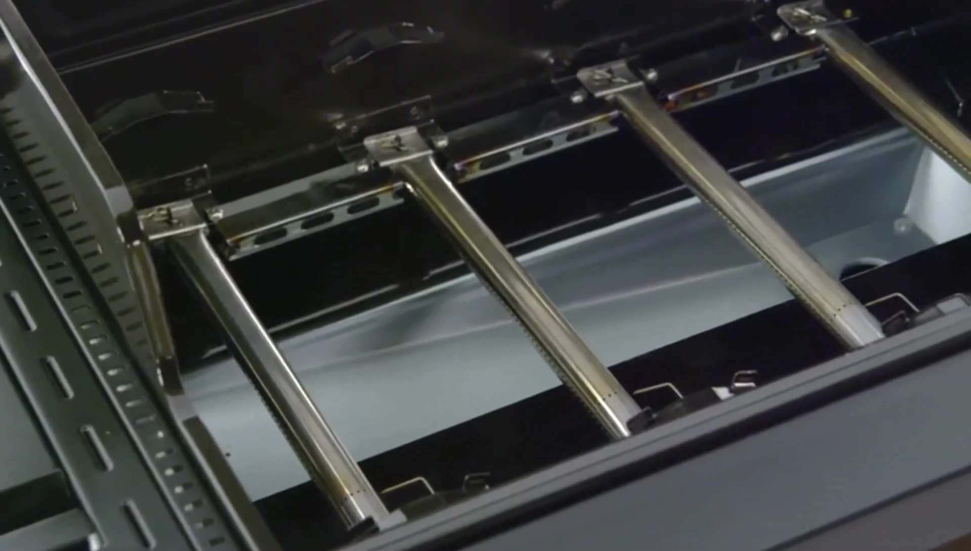 Close-up of the Dyna-Glo grill's burners and firebox