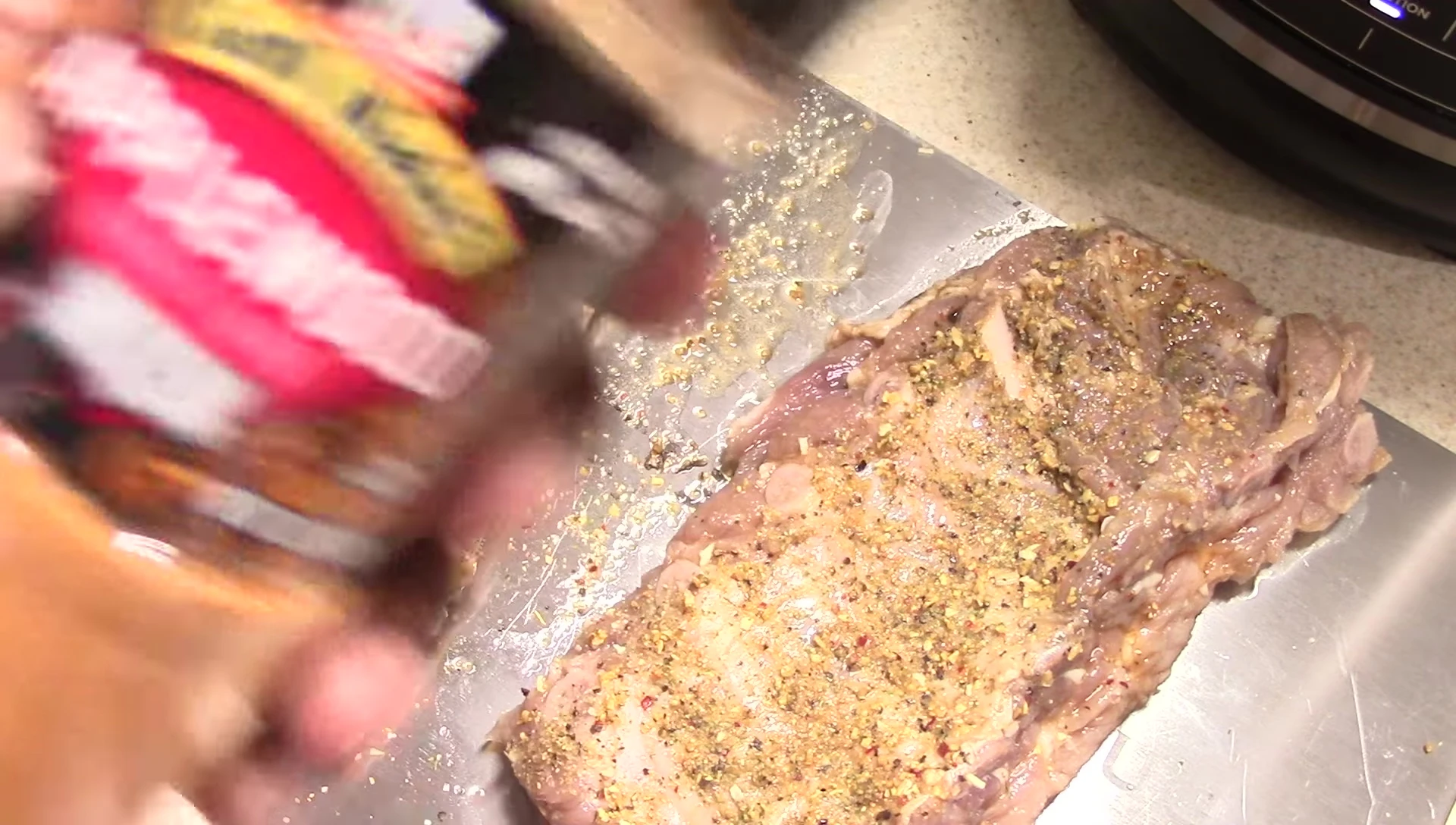 Applying applewood rub to the ribs.