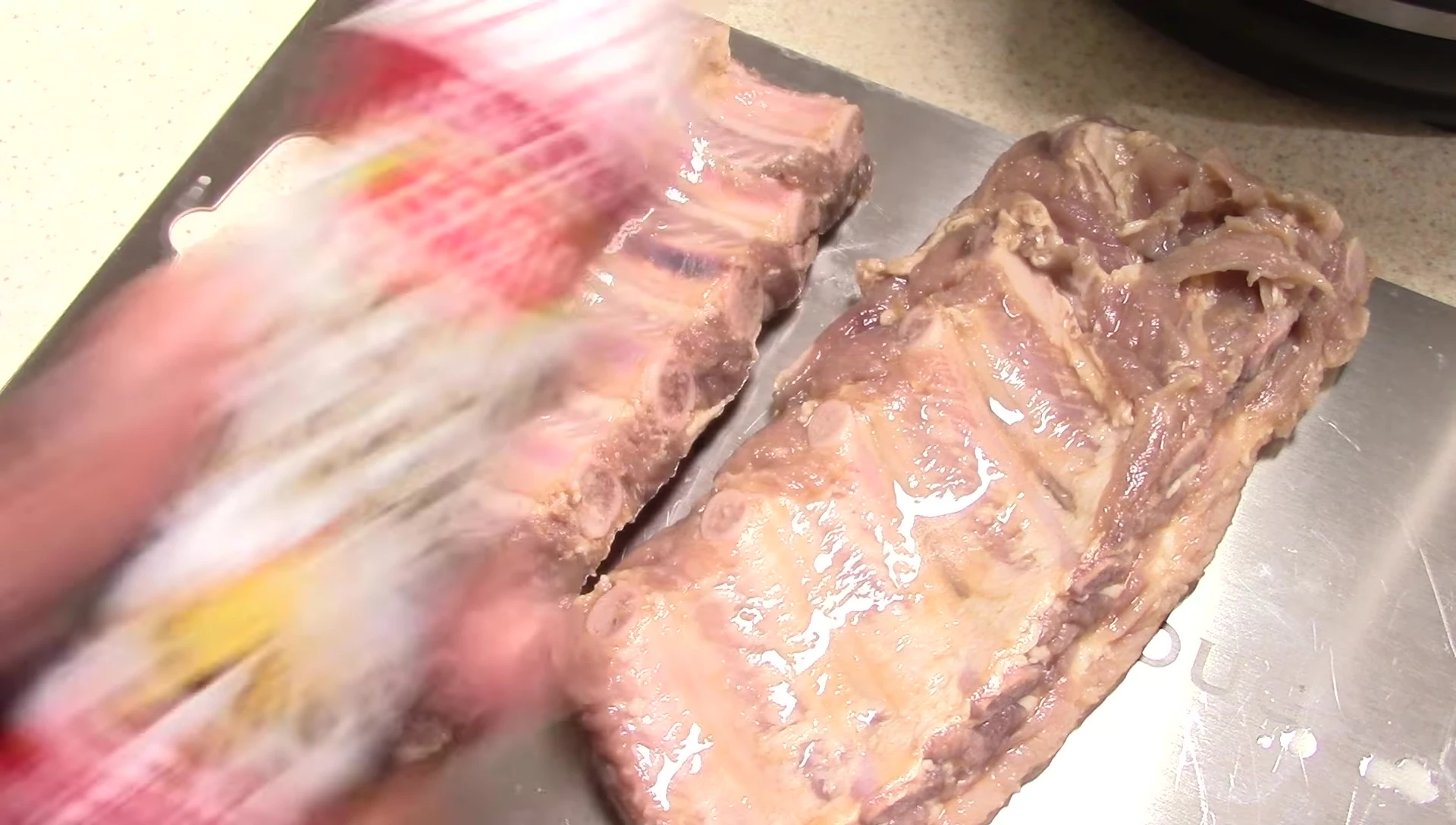 Adding liquid smoke to the ribs.