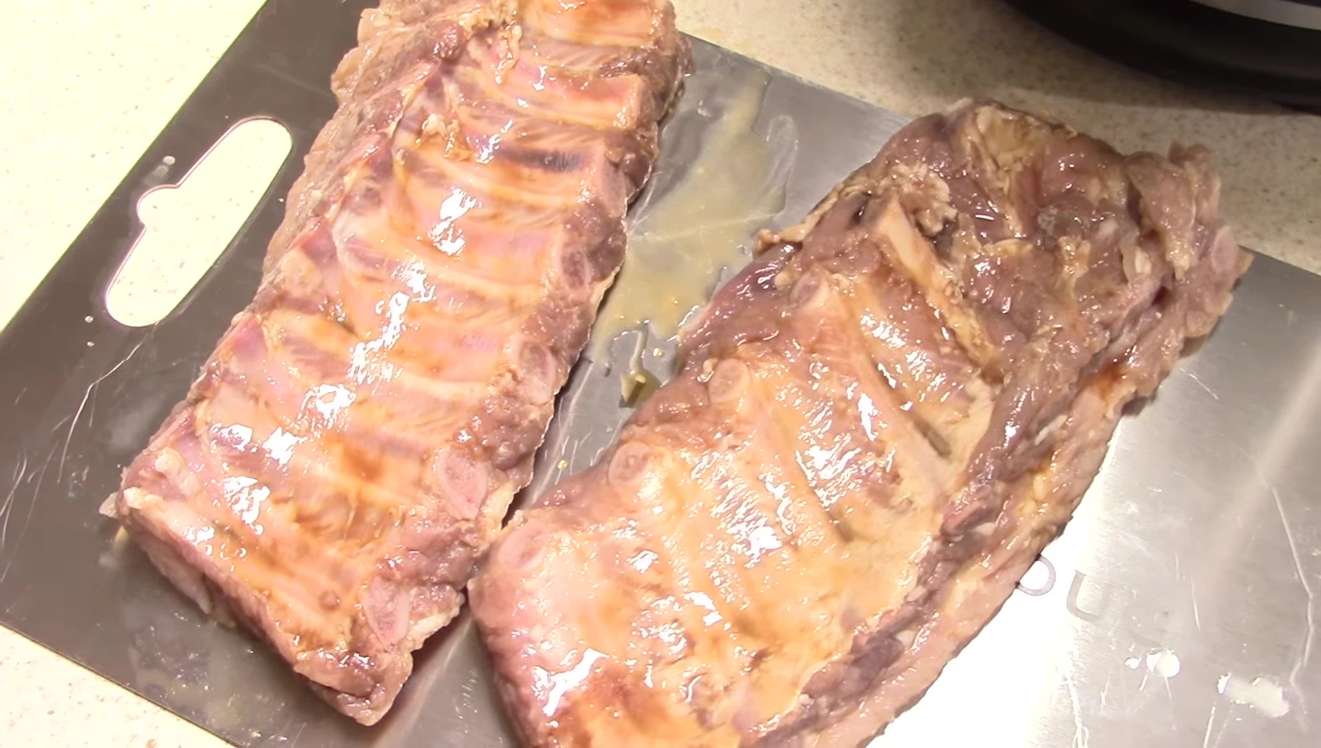 Seasoning the ribs with pink salt, black pepper, and garlic powder.