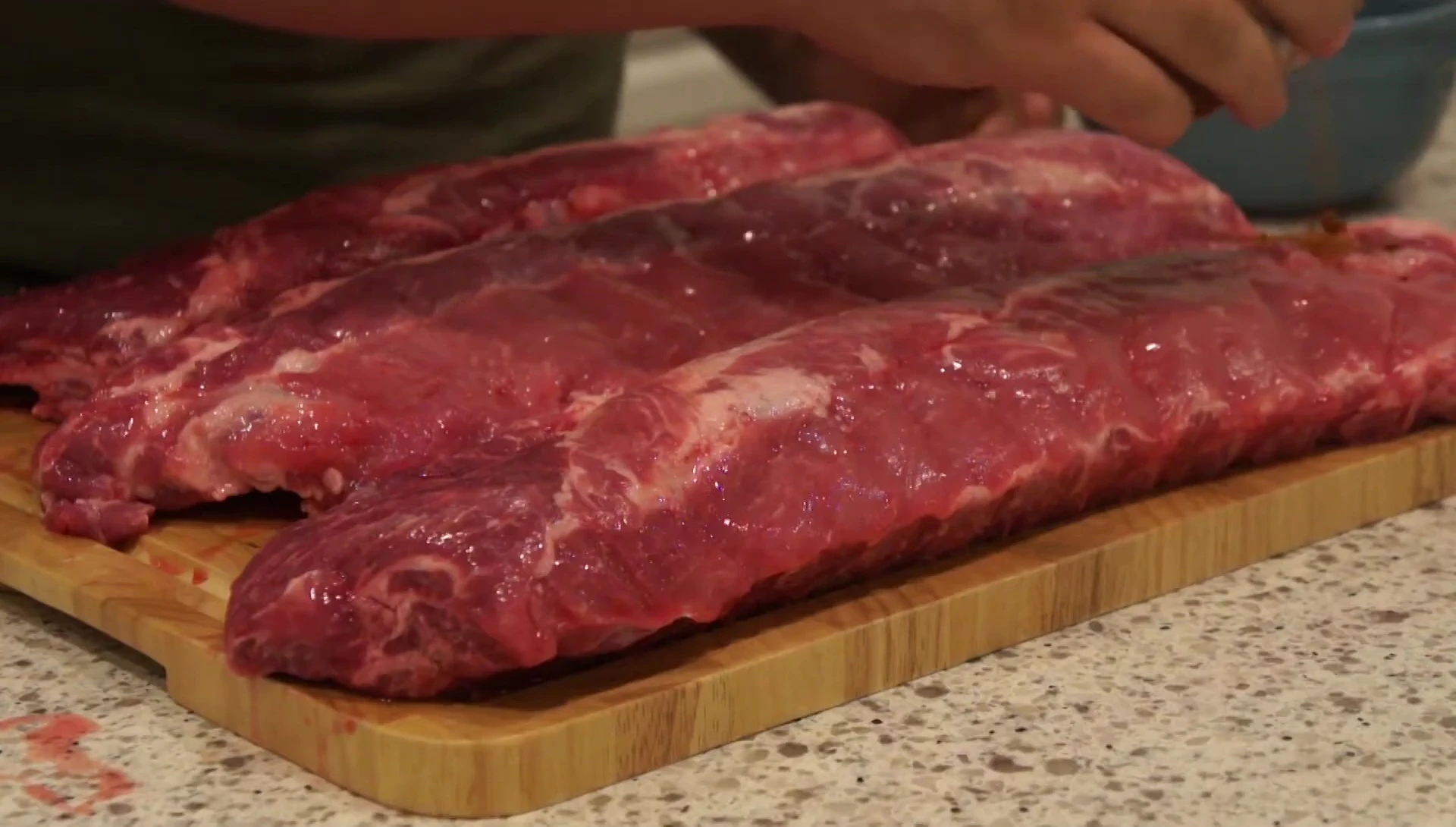 Applying Casey's spice rub to the ribs.
