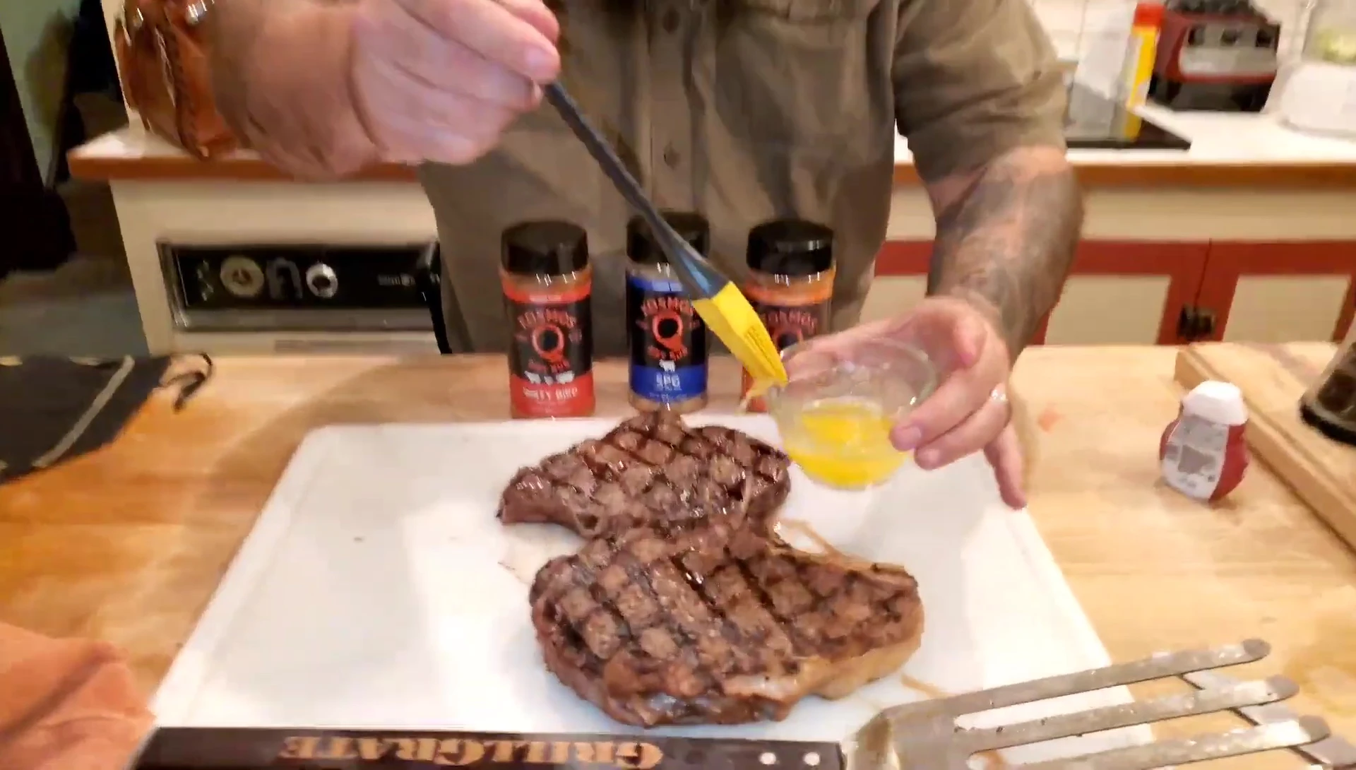 Drizzling melted butter over the steaks