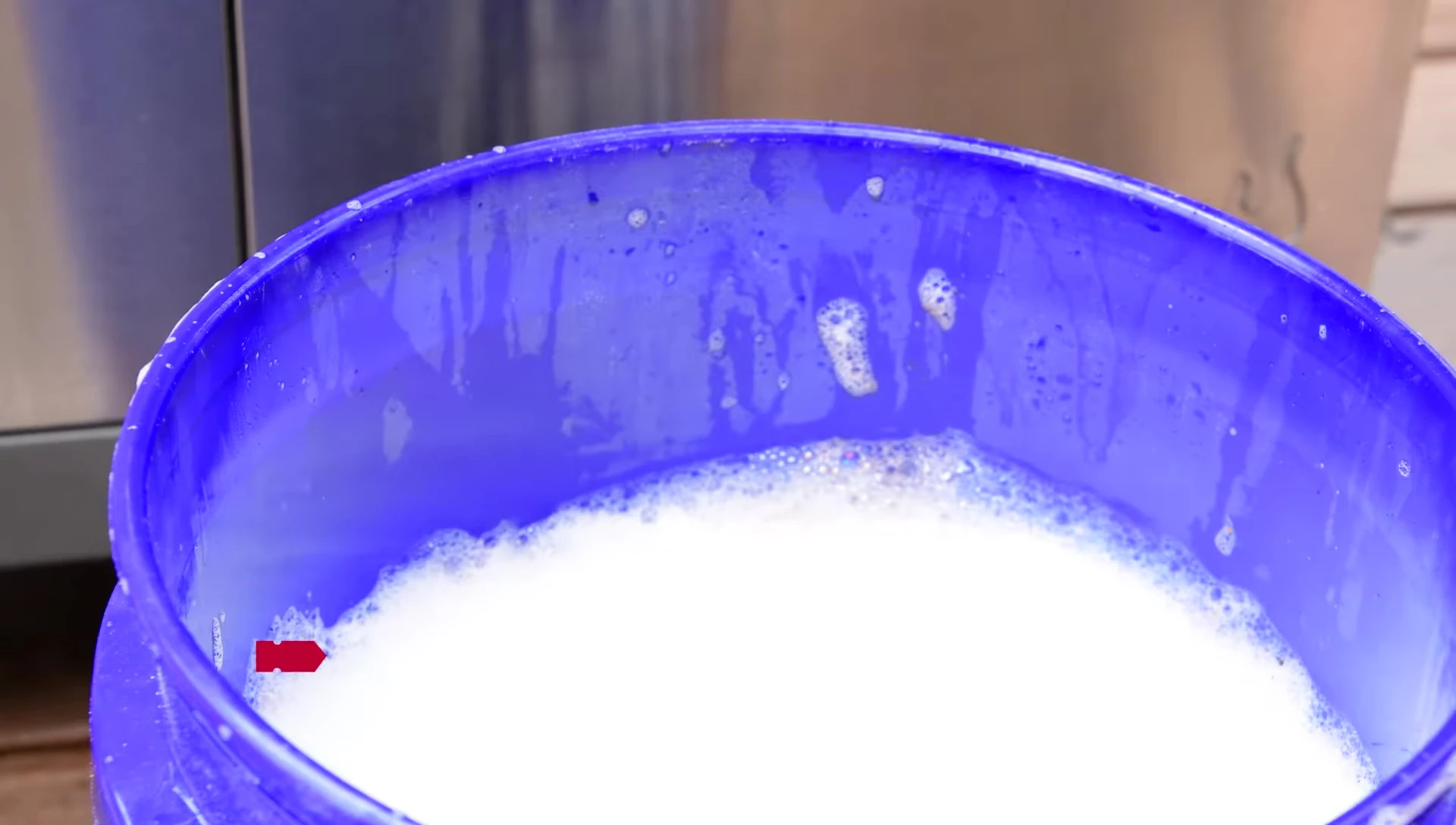 Cleaning the porcelain-coated grates with soapy water and a non-abrasive scrubber.