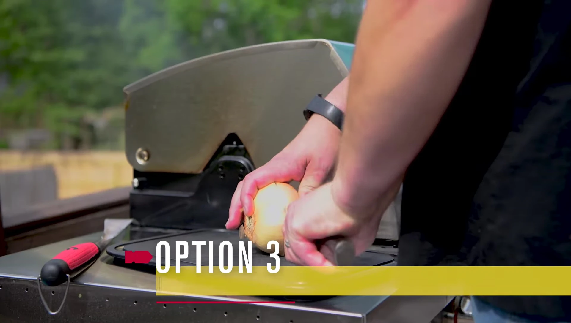 Cleaning the hot grates with a halved onion.