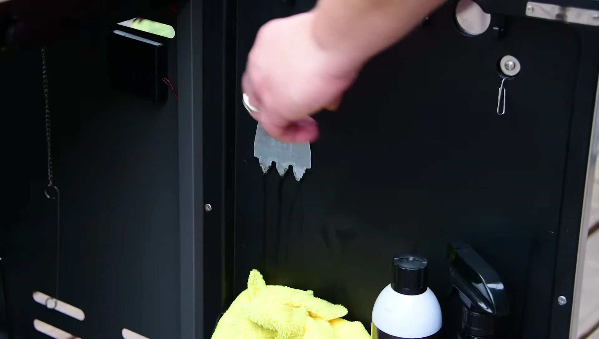 Using the cleaning tool on the infrared emitters.