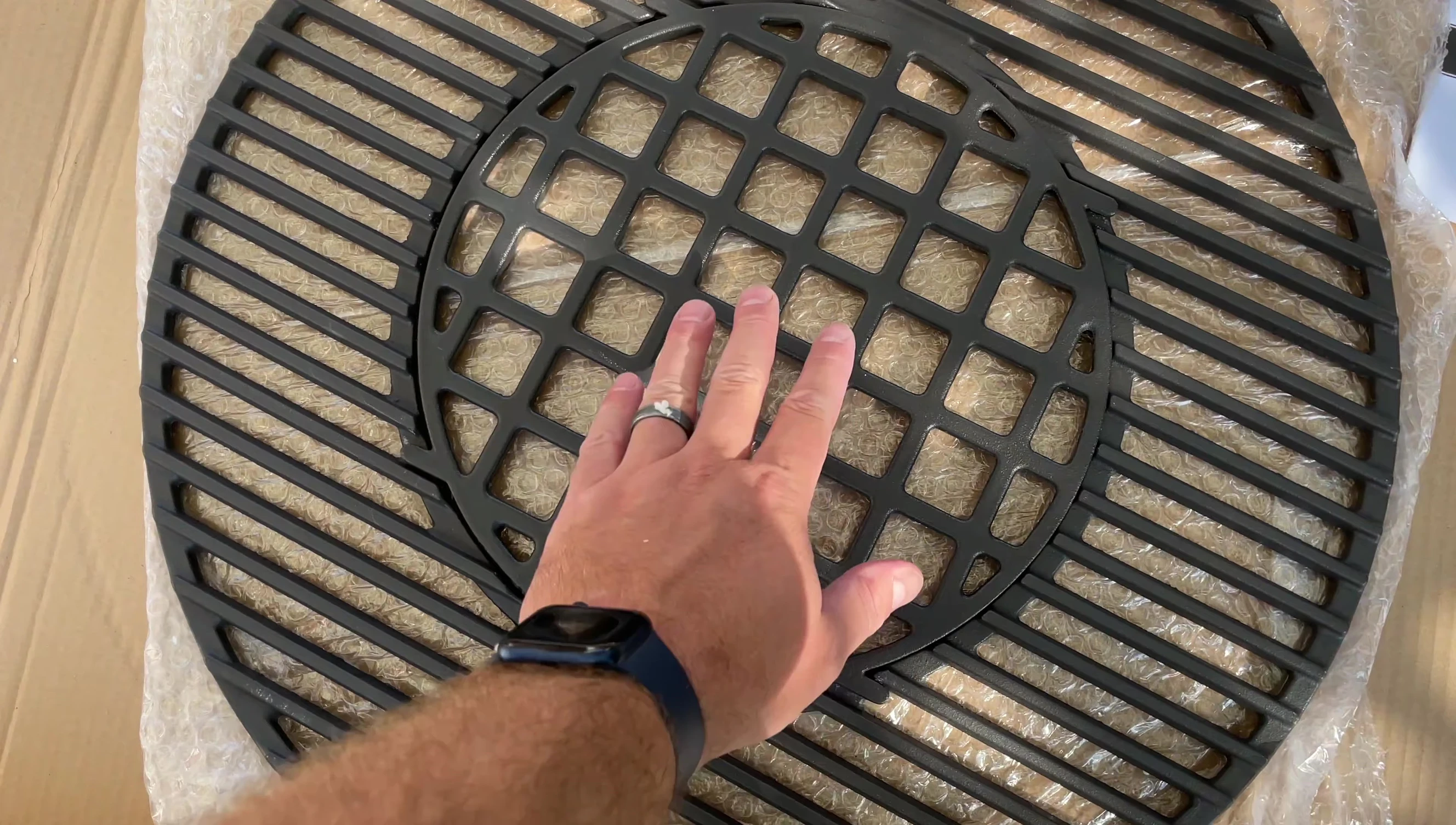 Detailed view of the grill grate, highlighting the two distinct grill patterns.
