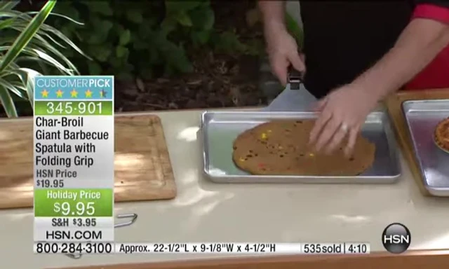 Spatula sliding under a baking sheet