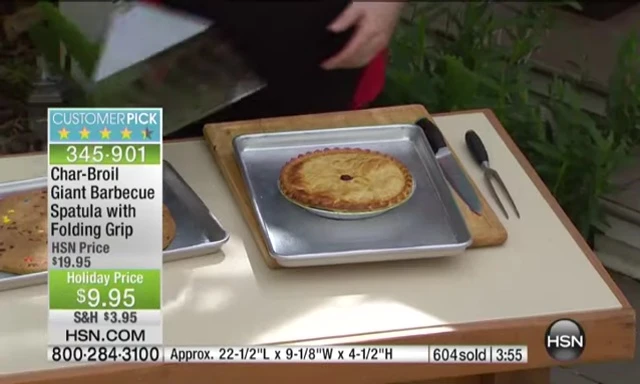 Spatula removing a pie from an oven