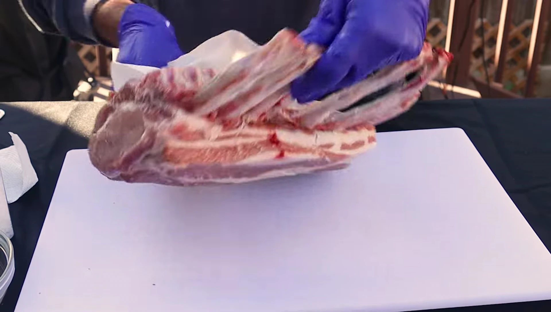 Removing the membrane from the pork rack.