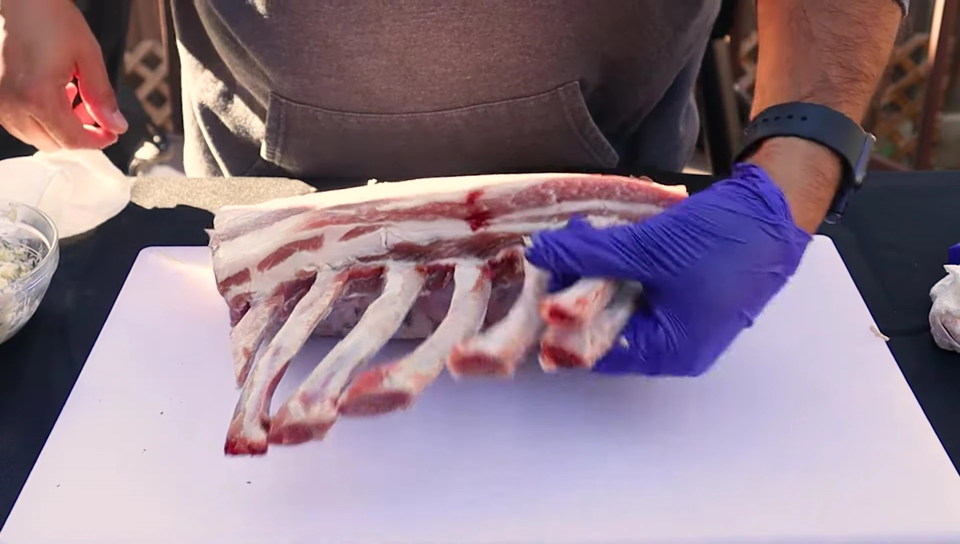 Seasoning the pork rack with coarse salt.