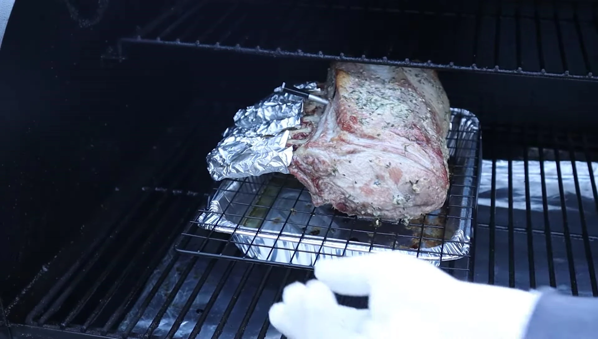 Rotating the pork rack during the smoking process.