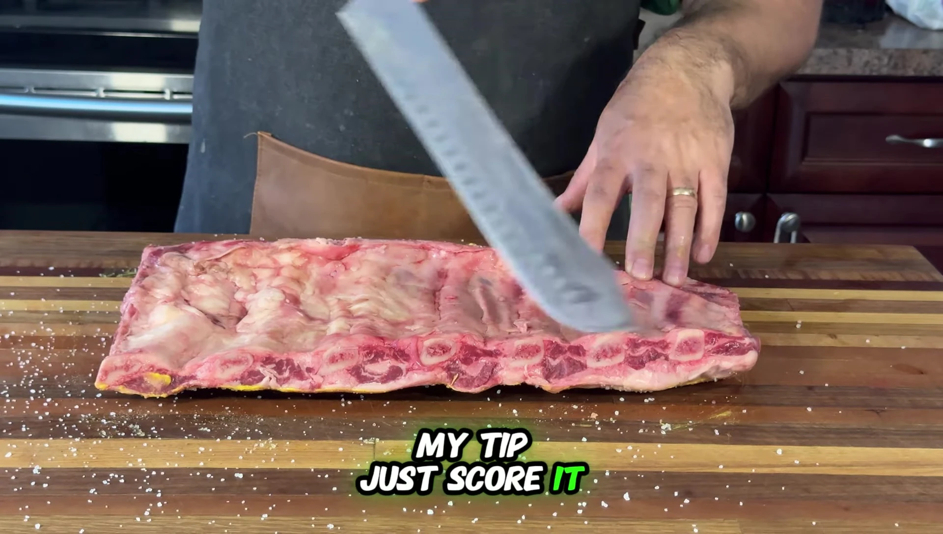 Close-up of someone scoring the rib membrane