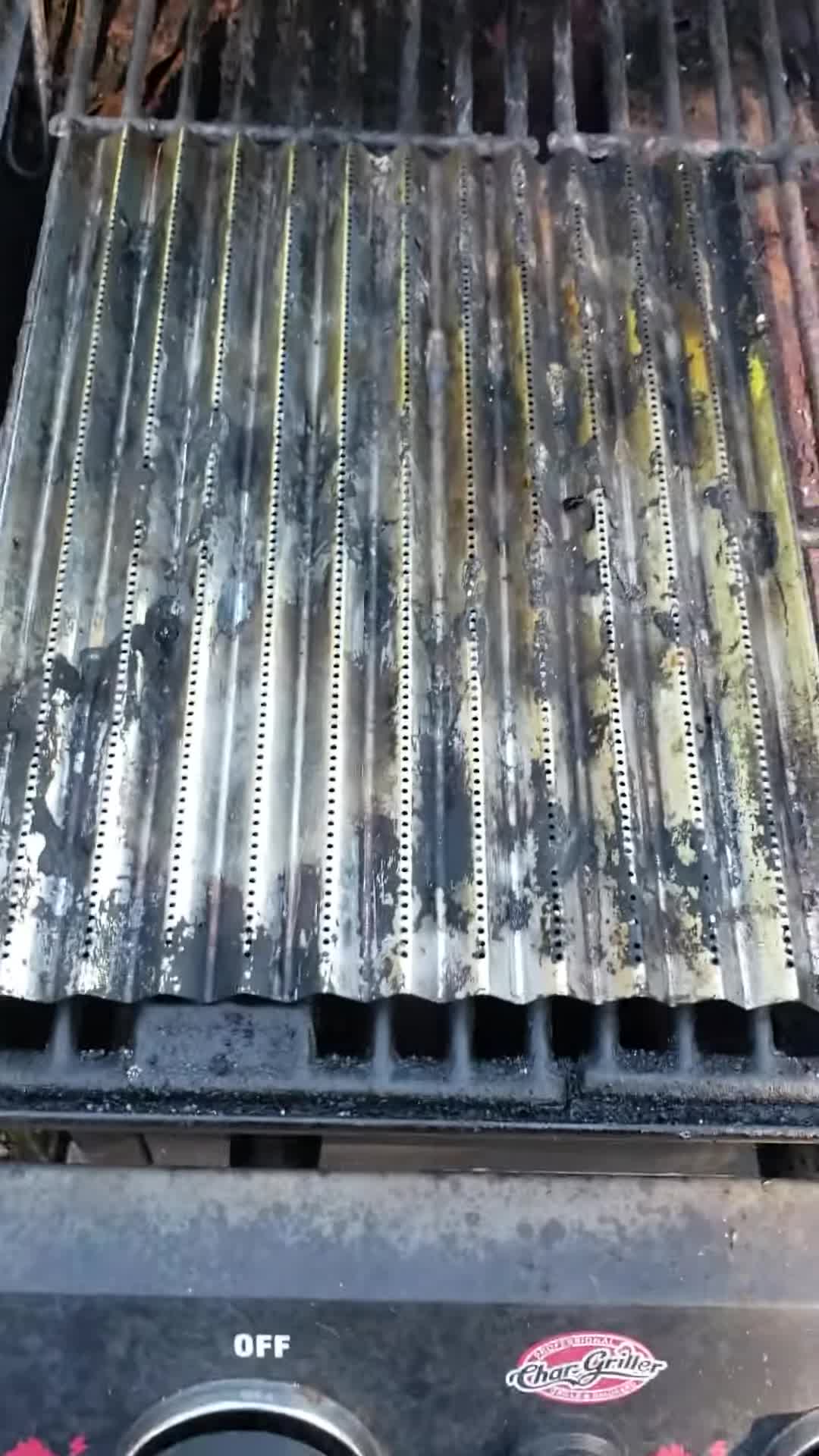 Close-up of the damaged Charbroil stainless steel grilling sheets after one use.
