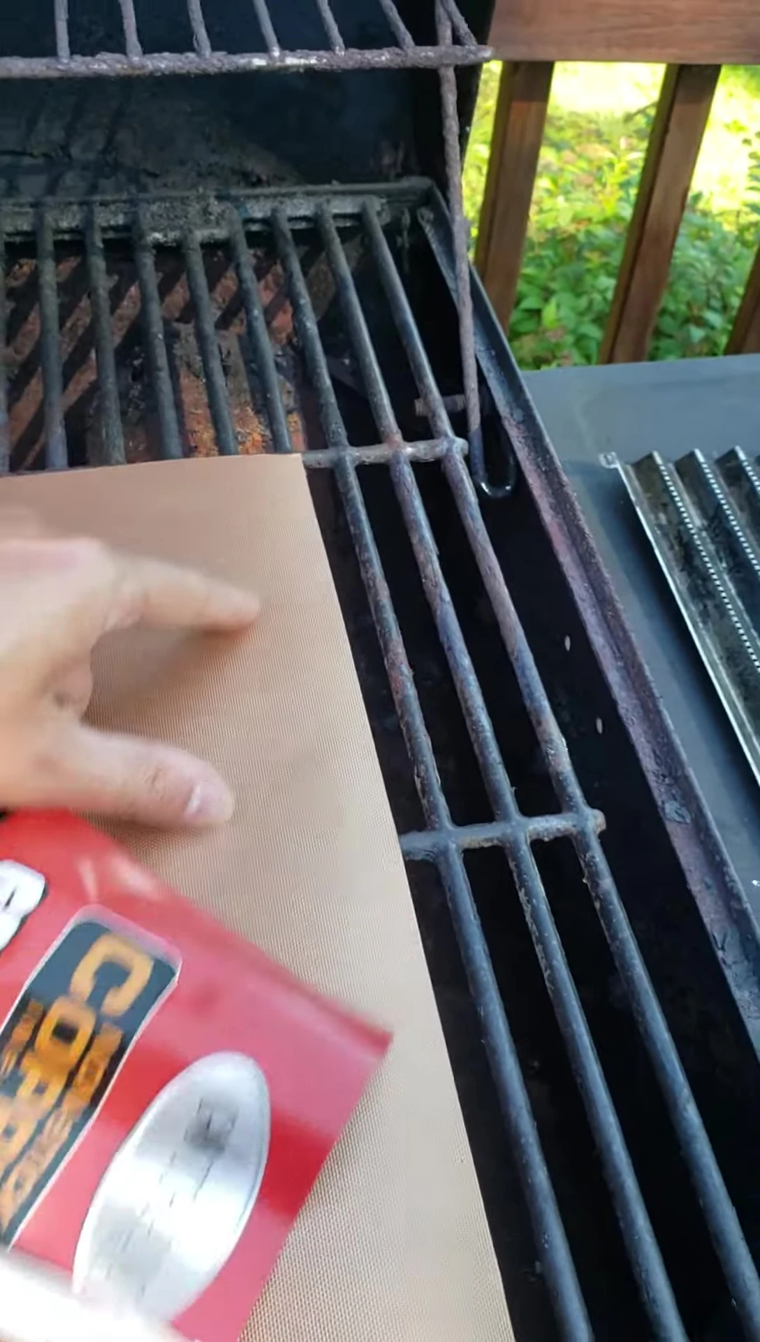 The Gotham Copper Grill Mat placed on the grill.