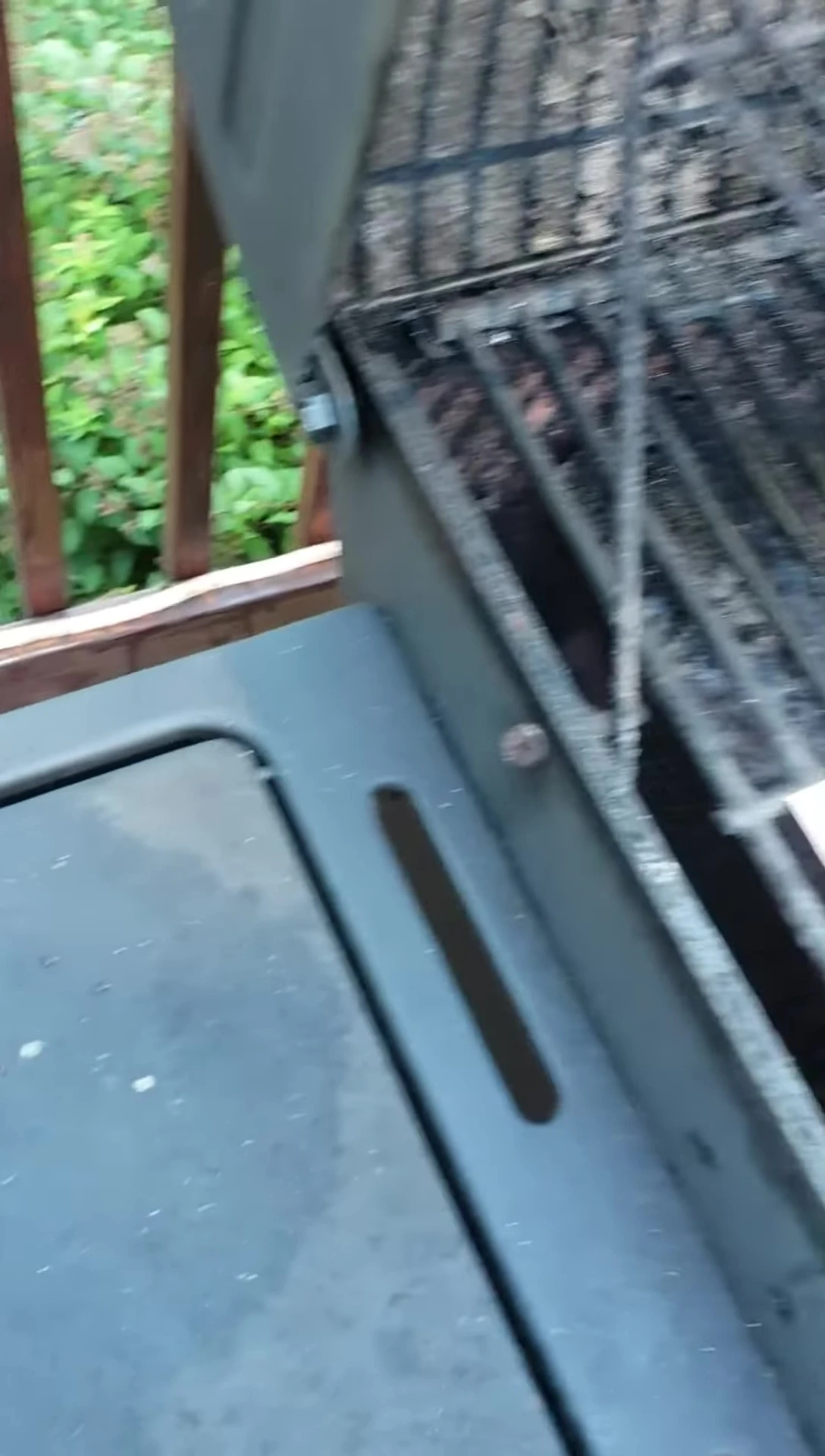 Chicken being placed on the Gotham Copper Grill Mat.