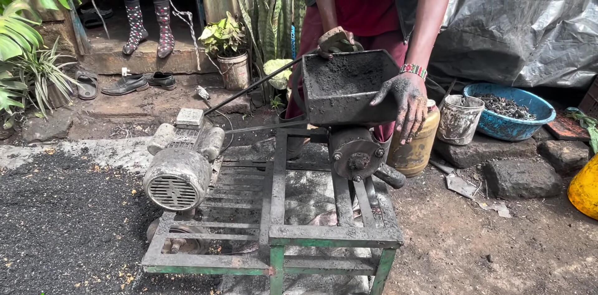 Counting the finished charcoal briquettes.