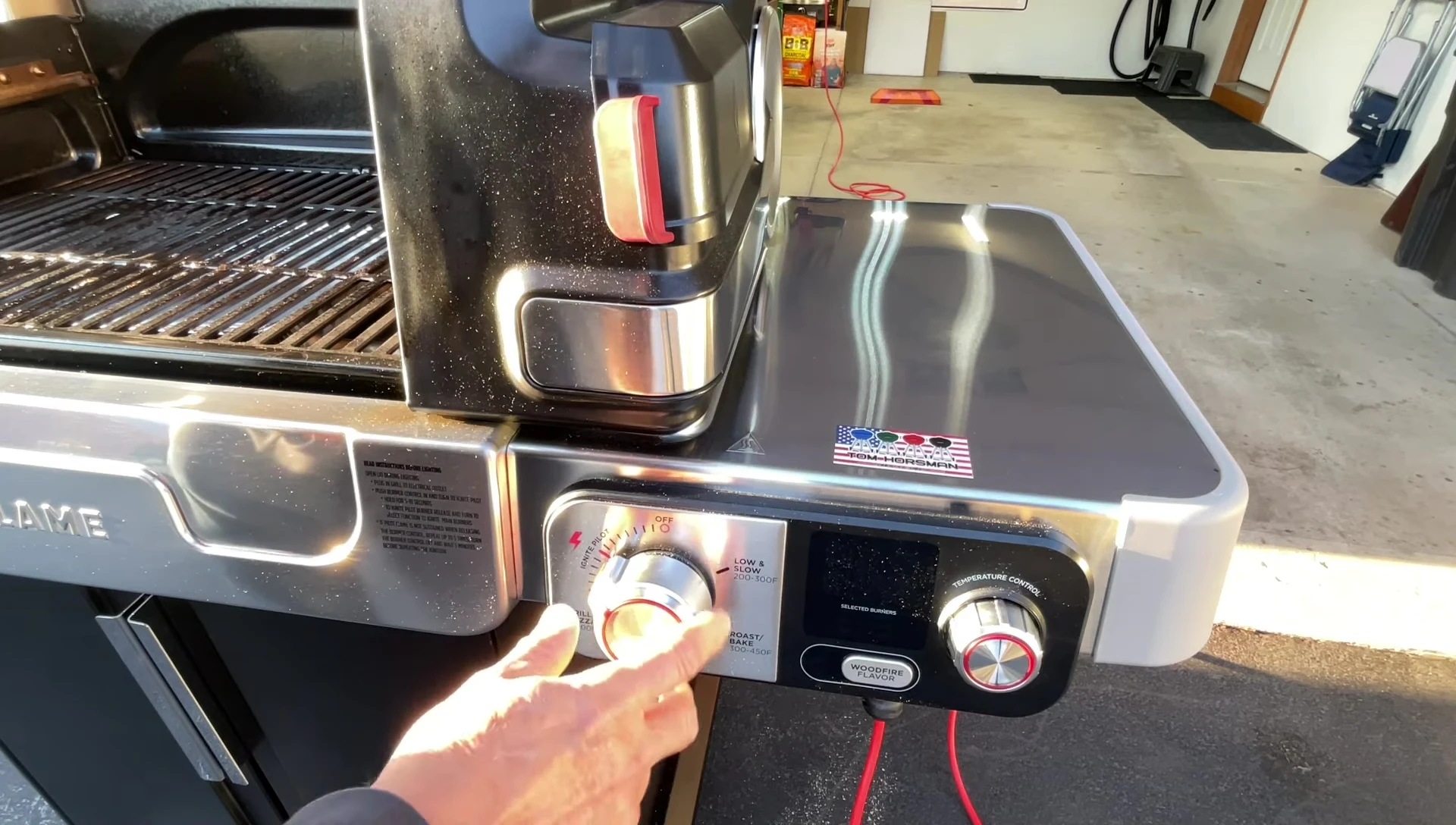 The grill is lit, and the pilot light is visible.