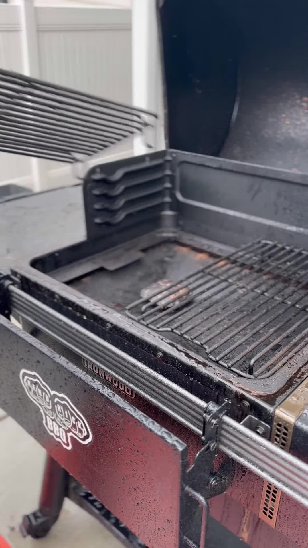 Removing the old grate from the Traeger grill.