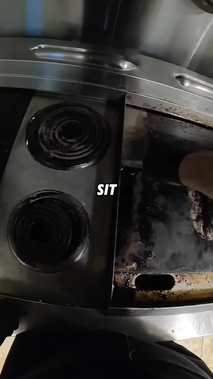 Use a scraper to remove the loosened grease and carbon deposits. Focus on areas above heating elements.