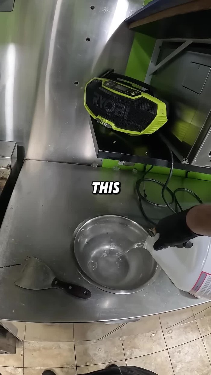 Use a scraper to remove the loosened grease and carbon deposits. Focus on areas above heating elements.