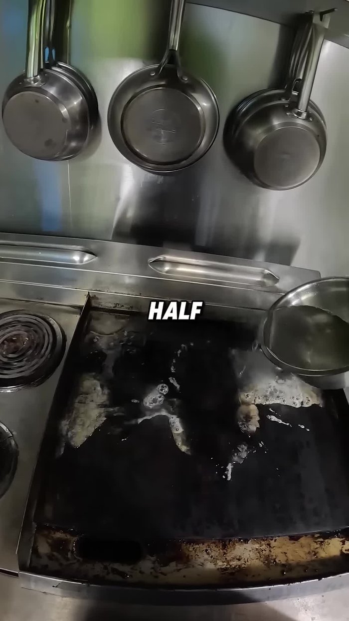 Use a scraper to remove the loosened grease and carbon deposits. Focus on areas above heating elements.