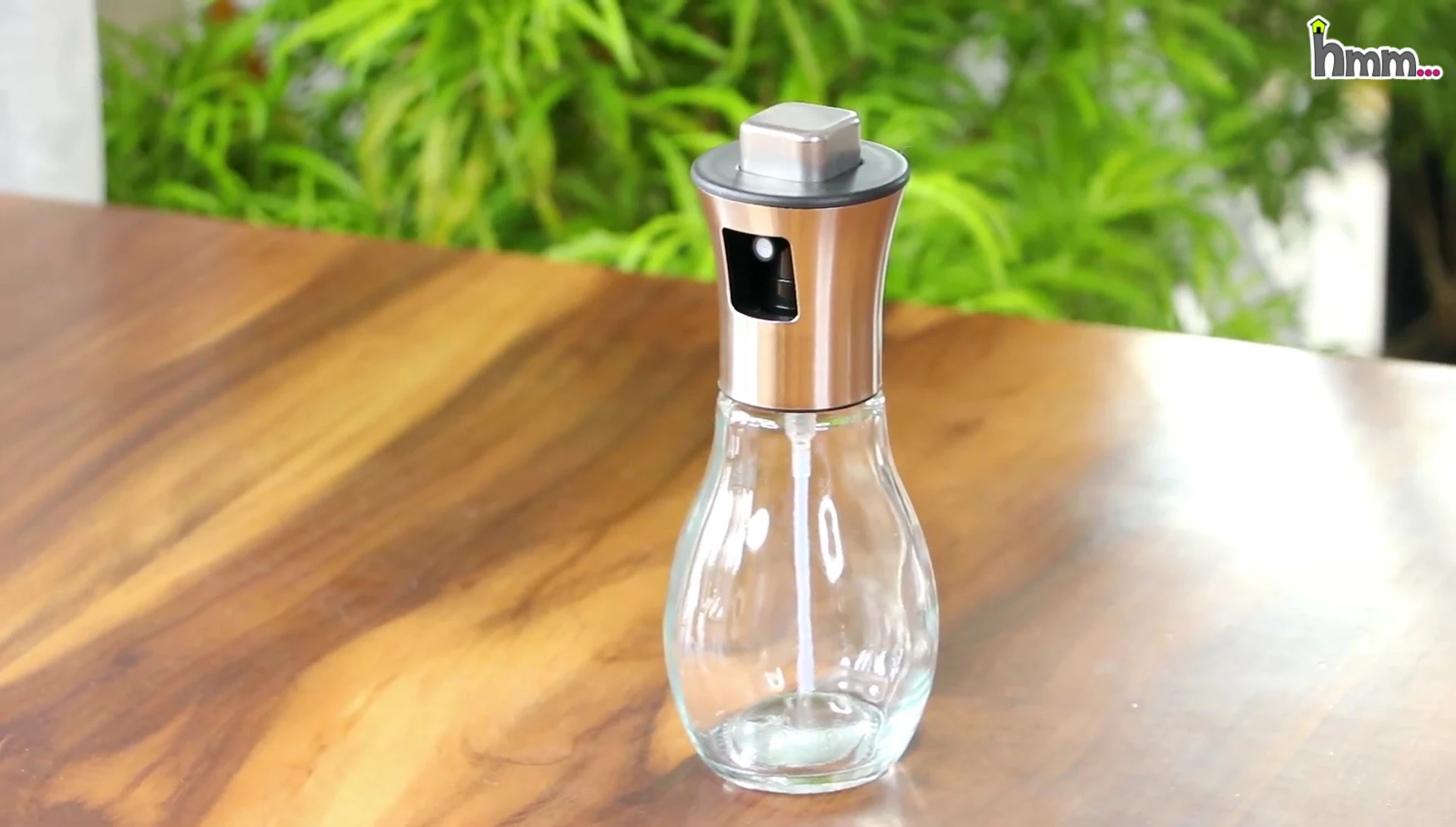 Oil spray bottle with top-mounted button
